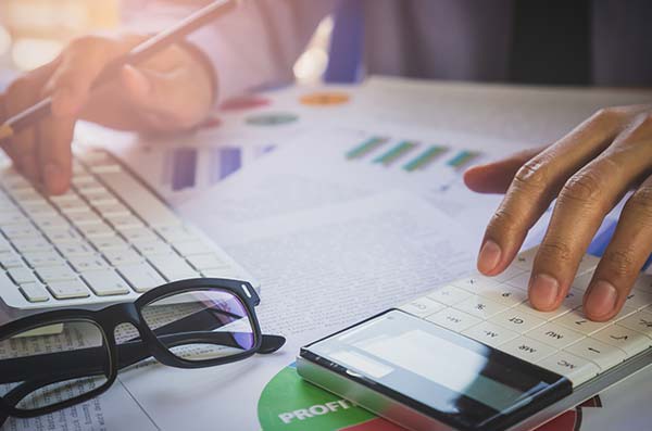 person calculating rates on calculator